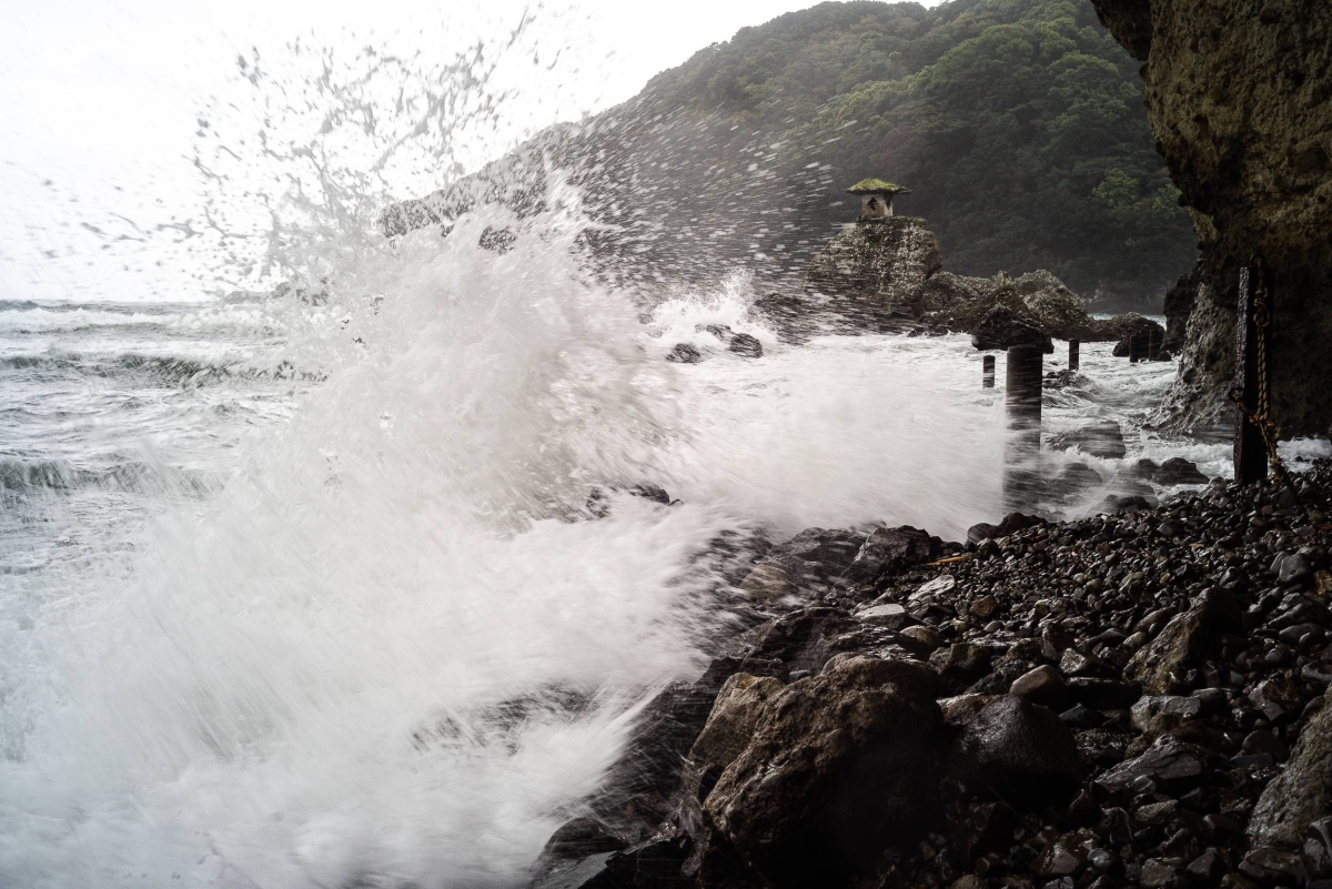 A small shrine perched atop rocks braves the waves hitting the shoreline during a storm in Shimoda, Shizuoka Prefecture. The area is under threat of a possible 31-meter-high tsunami if an earthquake strikes the nearby Nankai Trough. 